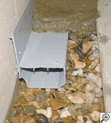 A no-clog basement french drain system installed in Pueblo